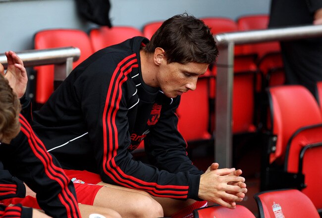 LIVERPOOL, ENGLAND - AUGUST 15:  Fernando Torres of Liverpool sits on the bench as a substitute during the Barclays Premier League match between Liverpool and Arsenal at Anfield on August 15, 2010 in Liverpool, England.  (Photo by Clive Brunskill/Getty Images)