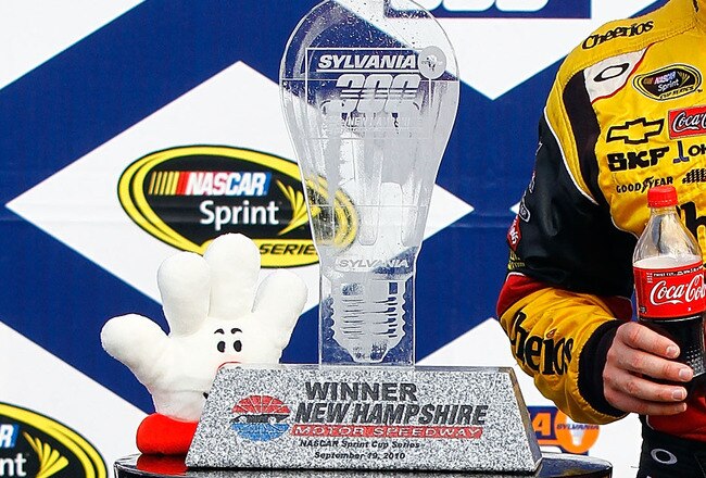 LOUDON, NH - SEPTEMBER 19:  Clint Bowyer, driver of the #33 Cheerios / Hamburger Helper Chevrolet, celebrates with the trophy in victory lane after winning the NASCAR Sprint Cup Series Sylvania 300 at New Hampshire Motor Speedway on September 19, 2010 in Loudon, New Hampshire.  (Photo by Jason Smith/Getty Images for NASCAR)