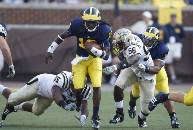 ANN ARBOR, MI - SEPTEMBER 5:  Denard Robinson #16 of the Michigan Wolverines carries the ball against T.J. Lynch #56 of the Western Michigan Broncos during the game on September 5, 2009 at Michigan Stadium in Ann Arbor, Michigan. (Photo by Gregory Shamus/Getty Images)