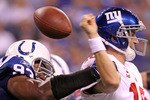 INDIANAPOLIS - SEPTEMBER 19:  Dwight Freeney #93 of the Indianapolis Colts hits Eli Manning #10 of the New York Giants causing a fumble during the NFL game at Lucas Oil Stadium on September 19, 2010 in Indianapolis, Indiana.  (Photo by Andy Lyons/Getty Images)