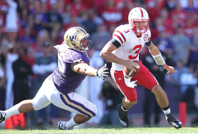 SEATTLE - SEPTEMBER 18: Quarterback Taylor Martinez #3 of the Nebraska Cornhuskers rushes against Sione Potoa'e #55 of the Washington Huskies on September 18, 2010 at Husky Stadium in Seattle, Washington. (Photo by Otto Greule Jr/Getty Images)
