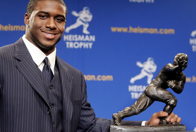 NEW YORK - DECEMBER 10:  Running back Reggie Bush #5 of the USC Trojans poses with the 2005 Heisman trophy after winning the award at the 71st Annual Heisman Ceremony on December 10, 2005 in New York City.  (Photo by Stephen Chernin/Getty Images)