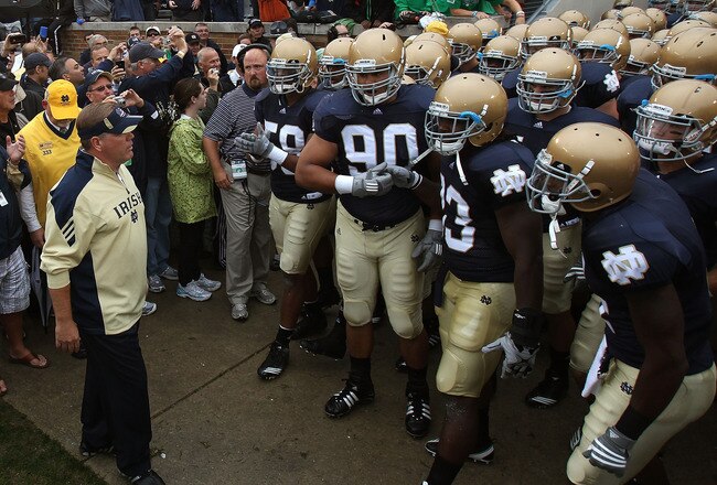 SOUTH BEND, IN - SEPTEMBER 11: Head coach Brian Kelly of the Notre Dame Fighting Irish (L) waits to enter the field with his team before a game against the Michigan Wolverines at Notre Dame Stadium on September 11, 2010 in South Bend, Indiana. Michigan defeated Notre Dame 28-24. (Photo by Jonathan Daniel/Getty Images)