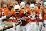AUSTIN, TX - NOVEMBER 07:  Wide receiver Malcolm Williams #9 of the Texas Longhorns stiff arms cornerback Justin Boddie #23 of the UCF Knights in the second quarter on November 7, 2009 at Darrell K Royal - Texas Memorial Stadium in Austin, Texas.  Texas won 35-3.  (Photo by Brian Bahr/Getty Images)
