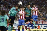 MADRID, SPAIN - SEPTEMBER 19: (L-R)Gerard Pique of Barcelona, Tiago Mendes of Atletico, Sergio Busquets of Barcelona and Antonio Lopez of Atletico jump for the ball during during the La Liga match between Atletico Madrid and Barcelona at Vicente Calderon Stadium on September 19, 2010 in Madrid, Spain. (Photo by Angel Martinez/Getty Images)