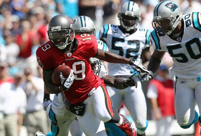 CHARLOTTE, NC - SEPTEMBER 19:  Mike Williams #19 of the Tampa Bay Buccaneers breaks a tackle on his way to scoring a touchdown against the Carolina Panthers during their game at Bank of America Stadium on September 19, 2010 in Charlotte, North Carolina.  (Photo by Streeter Lecka/Getty Images)