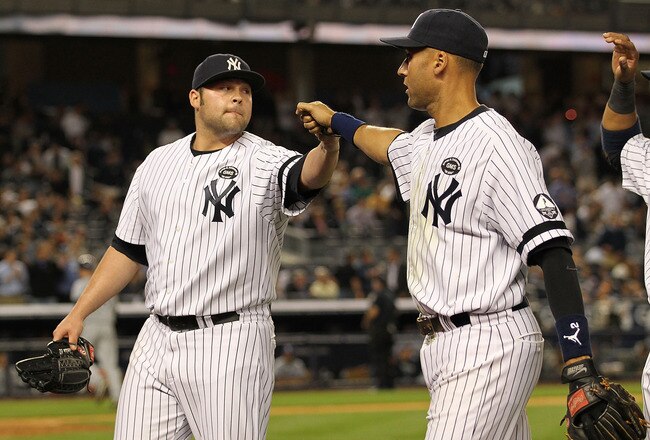 NEW YORK - SEPTEMBER 21:  Joba Chamberlain #62 and Derek Jeter #2 of the New York Yankees celebrate Chamberlain getting the side retired with the bases loaded in the eigth inning against the Tampa Bay Rays during their game on September 21, 2010 at Yankee Stadium in the Bronx borough of New York City.  (Photo by Al Bello/Getty Images)