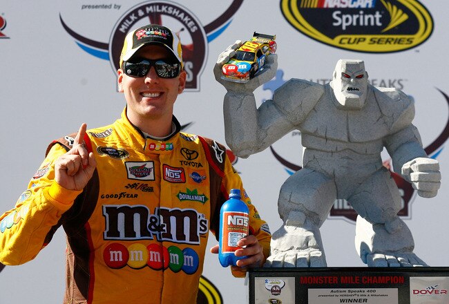 DOVER, DE - MAY 16:  Kyle Busch, driver of the #18 M&M's Toyota, poses in Victory Lane after winning the NASCAR Sprint Cup Series Autism Speaks 400 at Dover International Speedway on May 16, 2010 in Dover, Delaware.  (Photo by Jason Smith/Getty Images for NASCAR)