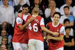 LONDON, ENGLAND - SEPTEMBER 21:  Samir Nasri (R) of Arsenal celebrates with teammates Marouane Chamakh (L) and Henri Lansbury (C) after scoring his team's third goal from the penalty spot during the Carling Cup third round match between Tottenham Hotspur and Arsenal at White Hart Lane on September 21, 2010 in London, England.  (Photo by Michael Regan/Getty Images)
