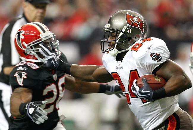 ATLANTA - NOVEMBER 29:  Cadillac Williams #24 of the Tampa Bay Buccaneers stiff arms Erik Coleman #26 of the Atlanta Falcons at Georgia Dome on November 29, 2009 in Atlanta, Georgia.  (Photo by Kevin C. Cox/Getty Images)