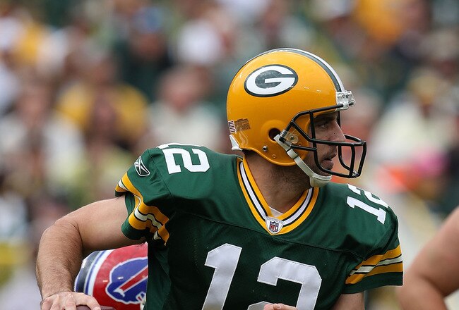 GREEN BAY, WI - SEPTEMBER 19: Aaron Rodgers #12 of the Green Bay Packers rolls out to look for a receiver against the Buffalo Bills at Lambeau Field on September 19, 2010 in Green Bay, Wisconsin. The Packers defeated the Bills 34-7. (Photo by Jonathan Daniel/Getty Images)