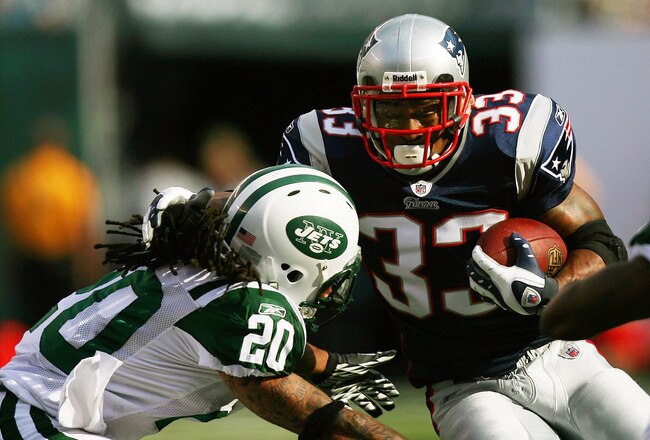 EAST RUTHERFORD, NJ - SEPTEMBER 19:  Kyle Wilson #20 of the New York Jets attempts to tackle Kevin Faulk #33 of the New England Patriots during the first quarter at the New Meadowlands Stadium on September 19, 2010 in East Rutherford, New Jersey.  (Photo by Andrew Burton/Getty Images)