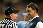 ATLANTA - SEPTEMBER 04:  Head coach Butch Davis of the North Carolina Tar Heels and Umpire Brent Sowell during the game against the LSU Tigers in the Chick-fil-A Kickoff Game at Georgia Dome on September 4, 2010 in Atlanta, Georgia.  (Photo by Kevin C. Cox/Getty Images)