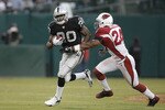 OAKLAND, CA - AUGUST 23:  Running back Darren McFadden #20 of the Oakland Raiders avoids defensive back Adrian Wilson #24 of the Arizona Cardinals during a preseason game on August 23, 2008 at the McAfee Coliseum in Oakland, California.  (Photo by Greg Trott/Getty Images)