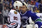 VANCOUVER, CANADA - MAY 11:  Goalie Roberto Luongo #1 of the Vancouver Canucks congratulates Dustin Byfuglien #33 of the Chicago Blackhawks while shaking hands after the Blackhawks defeated the Canucks 5-1 to win Game Six of the Western Conference Semifinals to win the series 4-2 during the 2010 NHL Stanley Cup Playoffs on May 11, 2010 at General Motors Place in Vancouver, British Columbia, Canada.  (Photo by Rich Lam/Getty Images)