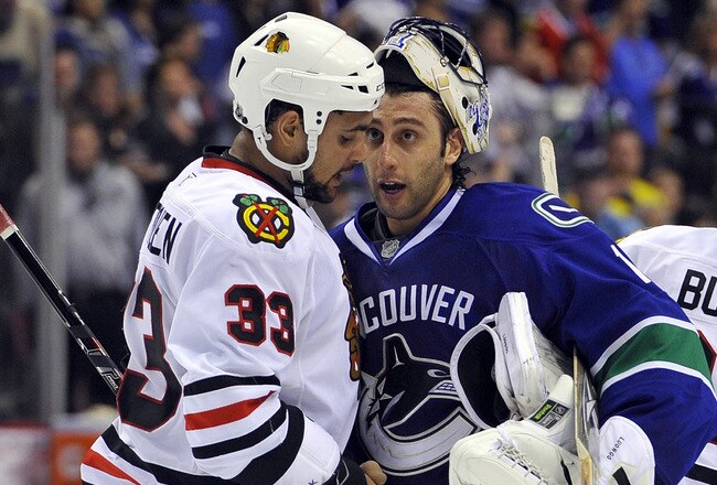 VANCOUVER, CANADA - MAY 11:  Goalie Roberto Luongo #1 of the Vancouver Canucks congratulates Dustin Byfuglien #33 of the Chicago Blackhawks while shaking hands after the Blackhawks defeated the Canucks 5-1 to win Game Six of the Western Conference Semifinals to win the series 4-2 during the 2010 NHL Stanley Cup Playoffs on May 11, 2010 at General Motors Place in Vancouver, British Columbia, Canada.  (Photo by Rich Lam/Getty Images)