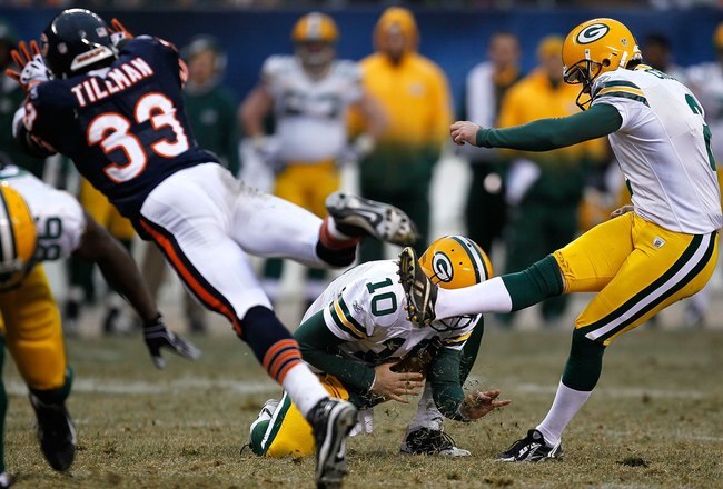CHICAGO - DECEMBER 13: Charles Tillman #33 of the Chicago Bears tries to block a field goal attempt by Mason Crosby #2 of the Green Bay Packers out of the hold of Matt Flynn #10 at Soldier Field on December 13, 2009 in Chicago, Illinois. The Packers defeated the Bears 21-14. (Photo by Jonathan Daniel/Getty Images)