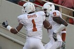 LUBBOCK, TX - SEPTEMBER 18:  Wide receiver Mike Davis #1 of the Texas Longhorns celebrates a touchdown with Malcolm Williams #9 against the Texas Tech Red Raiders at Jones AT&T Stadium on September 18, 2010 in Lubbock, Texas.  (Photo by Ronald Martinez/Getty Images)