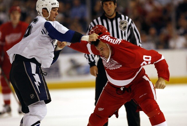 TAMPA, FL - SEPTEMBER 24: Andre Roy #36 of the Tampa Bay Lightning tangles with Aaron Downey #20 of the Detroit Red Wings during a NHL pre-season game at the St. Pete Times Forum on September 24, 2007 in Tampa, Florida. (Photo by Eliot J. Schechter/Getty Images)