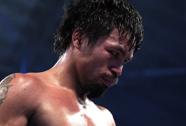 ARLINGTON, TX - MARCH 13:  Manny Pacquiao of the Philippines looks on in the ring against Joshua Clottey of Ghana during the WBO welterweight title fight at Cowboys Stadium on March 13, 2010 in Arlington, Texas. Pacquiao defeated Clottey by unanimous decision.  (Photo by Jed Jacobsohn/Getty Images)