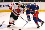 NEW YORK - SEPTEMBER 23:  Alexander Frolov #31 of the New York Rangers shoots the puck while Anton Volchenkov #28 of the New Jersey Devils defends during a preseason game at Madison Square Garden on September 23, 2010 in New York City.  (Photo by Andrew Burton/Getty Images)