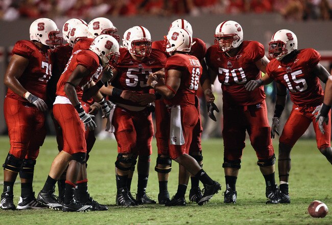 RALEIGH, NC - SEPTEMBER 16:  Russell Wilson #16 of the North Carolina State Wolfpack talks to his team in the huddle against the Cincinnati Bearcats during their game at Carter-Finley Stadium on September 16, 2010 in Raleigh, North Carolina.  (Photo by Streeter Lecka/Getty Images)