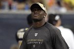 HOUSTON - AUGUST 22:  Running back Reggie Bush of the New Orleans Saints looks on from the sidelines against the Houston Texans on August 22, 2009 in Houston, Texas. An injured calf prevented him from playing.  (Photo by Bob Levey/Getty Images)