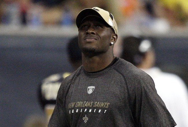 HOUSTON - AUGUST 22:  Running back Reggie Bush of the New Orleans Saints looks on from the sidelines against the Houston Texans on August 22, 2009 in Houston, Texas. An injured calf prevented him from playing.  (Photo by Bob Levey/Getty Images)
