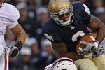 SOUTH BEND, IN - SEPTEMBER 25: Taylor Skaufel #40 of the Stanford Cardinal tackles Michael Floyd #3 of the Notre Dame Fighting Irish as Shayne Skov #11 closes in at Notre Dame Stadium on September 25, 2010 in South Bend, Indiana. Stanford defeated Notre Dame 37-14. (Photo by Jonathan Daniel/Getty Images)