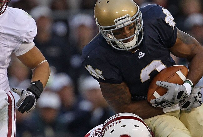 SOUTH BEND, IN - SEPTEMBER 25: Taylor Skaufel #40 of the Stanford Cardinal tackles Michael Floyd #3 of the Notre Dame Fighting Irish as Shayne Skov #11 closes in at Notre Dame Stadium on September 25, 2010 in South Bend, Indiana. Stanford defeated Notre Dame 37-14. (Photo by Jonathan Daniel/Getty Images)