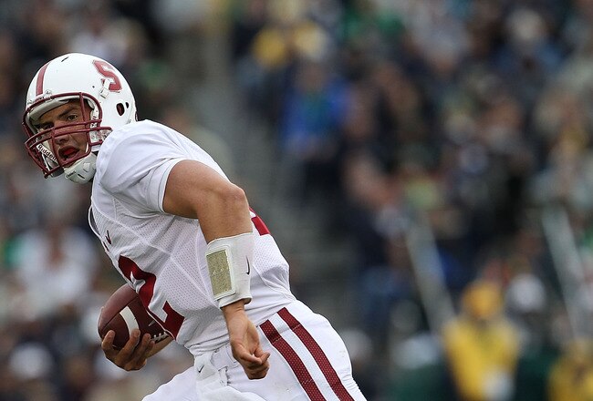 SOUTH BEND, IN - SEPTEMBER 25: Andrew Luck #12 of the Stanford Cardinal runs for yardage as Kerry Neal #56 of the Notre Dame Fighting Irish closes in at Notre Dame Stadium on September 25, 2010 in South Bend, Indiana. Stanford defeated Notre Dame 37-14. (Photo by Jonathan Daniel/Getty Images)