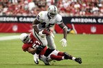 GLENDALE, AZ - SEPTEMBER 26:  Runningback Marcel Reece #45 of the Oakland Raiders is tackled by Paris Lenon #51 of the Arizona Cardinals after a reception during the NFL game at the University of Phoenix Stadium on September 26, 2010 in Glendale, Arizona.  The Cardinals defeated the Raiders 24-23. (Photo by Christian Petersen/Getty Images)