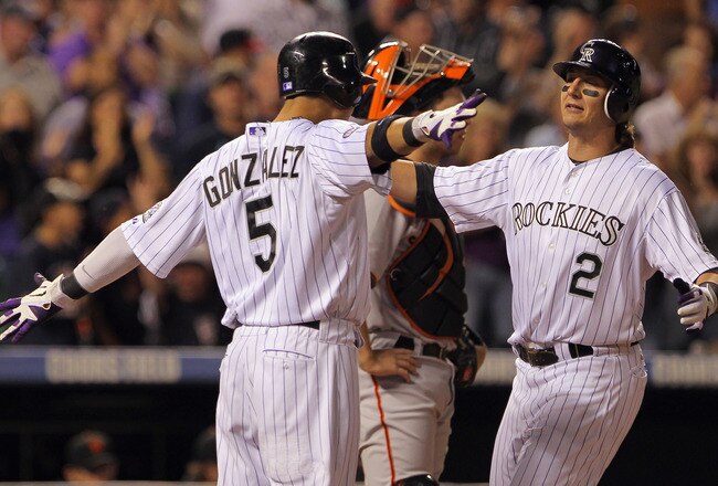 DENVER - SEPTEMBER 25:  Troy Tulowitzki #2 of the Colorado Rockies is welcomed home by Carlos Gonzalez #5 who scored on his two run homerun to give the Rockies a 5-4 lead over the San Francisco Giants in the fifth inning at Coors Field on September 25, 2010 in Denver, Colorado.  (Photo by Doug Pensinger/Getty Images)