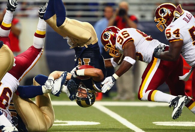 ST. LOUIS - SEPTEMBER 26: Danny Amendola #16 of the St. Louis Rams is flipped upside down against Chris Wilson #95 and H.B. Blades #54 both of the Washington Redskins at the Edward Jones Dome on September 26, 2010 in St. Louis, Missouri.  The Rams beat the Redskins 30-16.  (Photo by Dilip Vishwanat/Getty Images)
