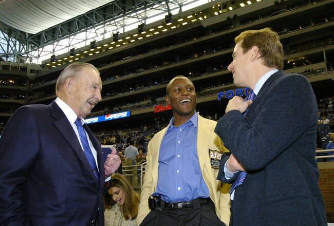 Detroit Lions owner William Clay Ford (left) and vice chairman William Clay Ford Jr. (right) talk wih Barry Sanders before play  against the Indianapolis Colts in a Thanksgiving Day game, November 25, 2005 in Detroit.  The Colts defeated the Lions 41 to 9.  (Photo by Al Messerschmidt/Getty Images)