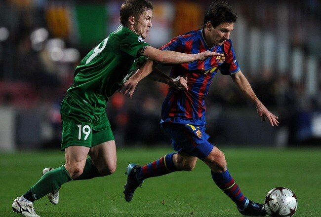 BARCELONA, SPAIN - OCTOBER 20:  Lionel Messi (R) of FC Barcelona duels for the ball with Vitali Kaleshin of FC Rubin Kazan during the UEFA Champions League group F match between FC Barcelona and FC Rubin Kazan at the Camp Nou Stadium on October 20, 2009 in Barcelona, Spain. Barcelona lost the match 2-1.  (Photo by Jasper Juinen/Getty Images)