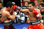 LAS VEGAS - DECEMBER 06:  Manny Pacquiao (R) hits Oscar De La Hoya in the fifth round of their welterweight bout at the MGM Grand Garden Arena December 6, 2008 in Las Vegas, Nevada.  (Photo by Ethan Miller/Getty Images)