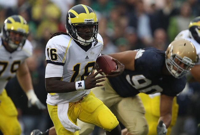 SOUTH BEND, IN - SEPTEMBER 11: Denard Robinson #16 of the Michigan Wolverines runs past Ethan Johnson #90 of the Notre Dame Fighting Irish at Notre Dame Stadium on September 11, 2010 in South Bend, Indiana. Michigan defeated Notre Dame 28-24.  (Photo by Jonathan Daniel/Getty Images)