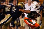 PITTSBURGH - SEPTEMBER 23:  Jacory Harris #12 of the Miami Hurricanes is tackled by Jabaal Sheard #97 of the Pittsburgh Panthers on September 23, 2010 at Heinz Field in Pittsburgh, Pennsylvania.  (Photo by Jared Wickerham/Getty Images)