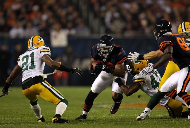 CHICAGO - SEPTEMBER 27:  Matt Forte #22 of the Chicago Bears runs the ball in the first quarter against Charles Woodson #21 and Morgan Burnett #42 of the Green Bay Packers at Soldier Field on September 27, 2010 in Chicago, Illinois.  (Photo by Jonathan Daniel/Getty Images)