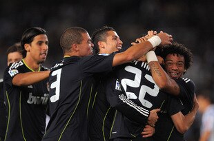 SAN SEBASTIAN, SPAIN - SEPTEMBER 18:  Angel di Maria (#22) of Real Madrid celebrates with teammates Sami Khedira (L) Pepe (2L), Cristiano Ronaldo and Marcelo (R) after scoring Real's first goal during the La Liga match between Real Sociedad and Real Madrid at Estadio Anoeta on September 18, 2010 in San Sebastian, Spain.  (Photo by Denis Doyle/Getty Images)
