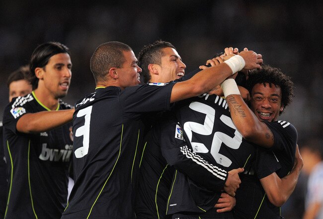 SAN SEBASTIAN, SPAIN - SEPTEMBER 18:  Angel di Maria (#22) of Real Madrid celebrates with teammates Sami Khedira (L) Pepe (2L), Cristiano Ronaldo and Marcelo (R) after scoring Real's first goal during the La Liga match between Real Sociedad and Real Madrid at Estadio Anoeta on September 18, 2010 in San Sebastian, Spain.  (Photo by Denis Doyle/Getty Images)