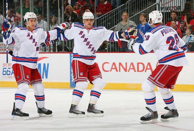 NEWARK, NJ - JANUARY 10:  Vinny Prospal #20 of the New York Rangers celebrates his first-period goal with teammates Marian Gaborik #10 and Michael del Zotto #4 during NHL action against the New Jersey Devils at the Prudential Center on March 10, 2010 in Newark, New Jersey. (Photo by Mike Stobe/Getty Images)