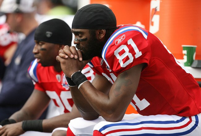 MIAMI - DECEMBER 06:  Wide receivers Sam Aiken #88 and Randy Moss #81 of the New England Patriots sit on the sidelines while taking on the Miami Dolphins at Land Shark Stadium on December 6, 2009 in Miami, Florida. The Dolphins defeated the Patriots 22-21.  (Photo by Doug Benc/Getty Images)