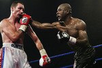 SHEFFIELD- NOVEMBER 7: Clinton Woods of Great Britain (left) in action against Glencoffe Johnson of Jamaica (right) during the IBF Light Heavyweight title fight held at the Hillsborough Leisure Centre in Sheffield,England on the 7th of November 2003. (Photo by John Gichigi/Getty Images)  The fight ended in a draw.