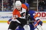 UNIONDALE, NY - MARCH 28:  Claude Giroux #28 of the Philadelphia Flyers moving the puck past Joel Rechlicz #40 of the New York Islanders in a National Hockey League game on March 28, 2009 in Uniondale, New York.  (Photo by Paul Bereswill/Getty Images)