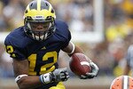 ANN ARBOR, MI - SEPTEMBER 25: Roy Roundtree #12 of the Michigan Wolverines runs for a 32 yard gain after catching the pass from Denard Robinson during the first quarter of the game against Bowling Green on September 25, 2010 at Michigan Stadium in Ann Arbor, Michigan. Michigan defeated Bowling Green 65-21.  (Photo by Leon Halip/Getty Images)