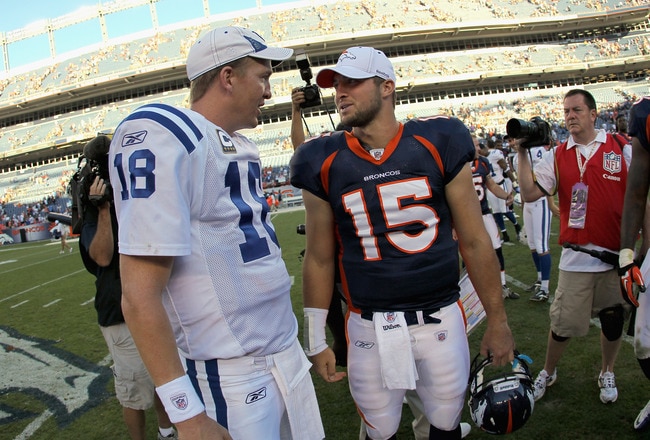 DENVER - SEPTEMBER 26:  Quarterback Peyton Manning #18 of the Indianapolis Colts and quarterback Tim Tebow #15 of the Denver Broncos meet at midfield after the game at INVESCO Field at Mile High on September 26, 2010 in Denver, Colorado. The Colts defeated the Broncos 27-13  (Photo by Doug Pensinger/Getty Images)