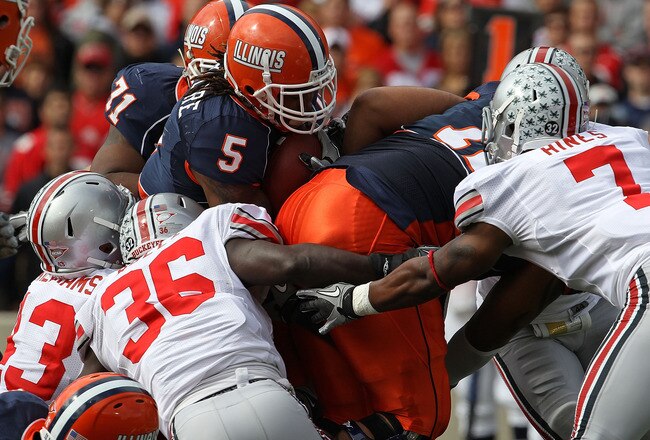 CHAMPAIGN, IL - OCTOBER 02: (L-R) Nathan Williams #43, Brian Rolle #36 and Jermale Hines #7 of the Ohio State Buckeyes stop Mikel Leshoure #5 of the Illinois Fighting Illini at Memorial Stadium on October 2, 2010 in Champaign, Illinois. Ohio State defeated Illinois 24-13. (Photo by Jonathan Daniel/Getty Images)