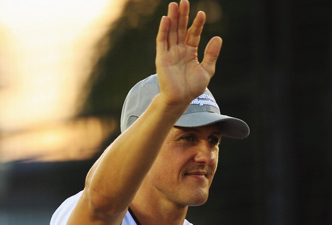 SINGAPORE - SEPTEMBER 26:  Michael Schumacher of Germany and Mercedes GP attends the drivers parade before the Singapore Formula One Grand Prix at the Marina Bay Street Circuit on September 26, 2010 in Singapore.  (Photo by Mark Thompson/Getty Images)